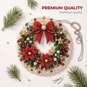 Detailed view of a DIY Christmas pearl art wreath with red poinsettia and large bow.