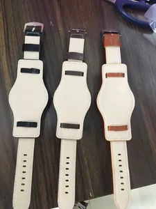 Close-up detail view of three different leather Bund watch straps in black and brown