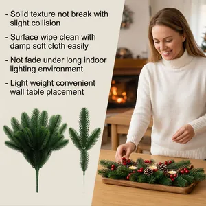 Artificial pine branches shown in a decorative Christmas centerpiece on a table