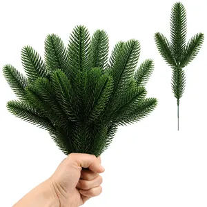 Realistic artificial pine branches for Christmas wreaths and DIY home holiday decorations.