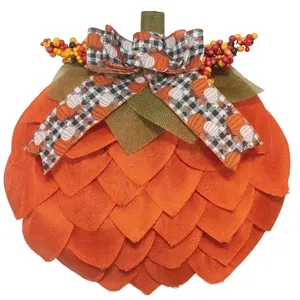 Detailed view of handmade orange fabric pumpkin wreath for autumn decor