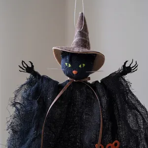 Decorative hanging Halloween witch cat doll featuring a black mesh cloak and brown hat