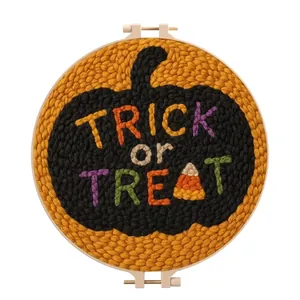 Detailed view of Halloween pumpkin punch needle embroidery with "Trick or Treat" text.