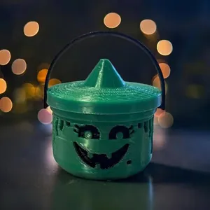 Close-up of a green 3D-printed Spooky Mini Boo Bucket with a smiling face