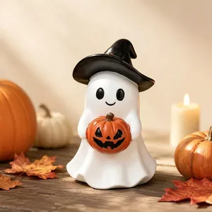 Detail view of a ceramic ghost figurine holding a pumpkin in a cozy Halloween setting