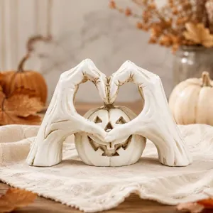 Detail view of a white skeleton hand heart-shaped Halloween pumpkin tabletop ornament