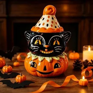 Detailed close-up of a festive Halloween ceramic black cat jar atop a pumpkin base.