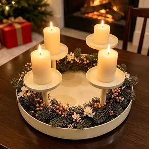 Detailed view of a white 4-cup metal Christmas wreath candle holder on a dining table