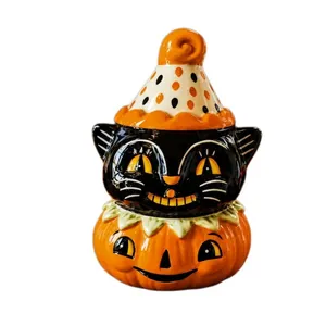 Detail of ceramic Halloween black cat on pumpkin ornament with glossy finish