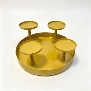 Macro view of a four-cup gold iron candle holder centerpiece for Christmas table decor