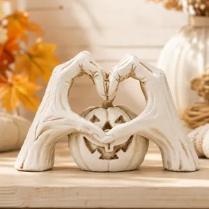 Elegant Halloween white heart-shaped skeleton hands framing a smiling pumpkin statue
