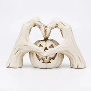 Spooky white Halloween pumpkin ornament featuring skeleton hands forming a decorative heart shape
