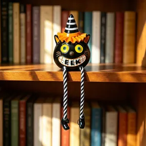 Halloween resin black cat figurine with hanging legs and orange striped witch hat decor