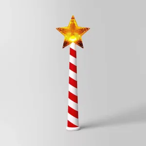 Close-up of a lit star magic wand Christmas light with red and white striped handle