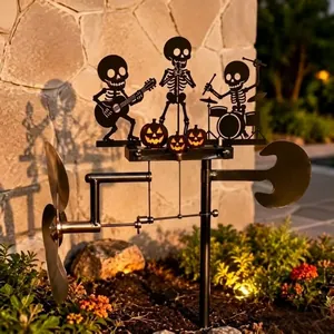 Outdoor Halloween skeleton metal drummer kinetic wind spinner in a beautiful garden setting