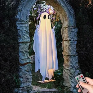 Detailed view of large glowing white ghost on a swing for Halloween garden decor