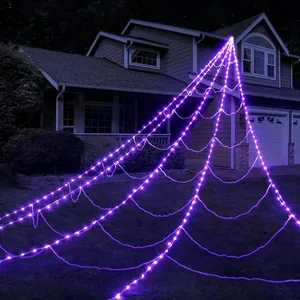 Detailed night view of giant purple LED spider web lights for outdoor Halloween decor
