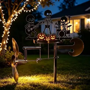 Skeleton band kinetic wind spinner installed in a night garden for Halloween decor