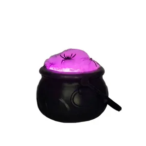 Halloween black witch cauldron tabletop decoration with glowing purple smoke and spiders