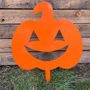 Detailed close-up view of a vibrant orange metal pumpkin garden stake for Halloween