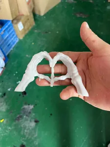 White resin skeleton hands forming a heart shape for creative Halloween party decor