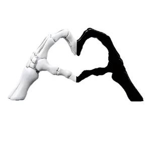 Detailed macro view of creative black and white resin skeleton hands forming a heart shape