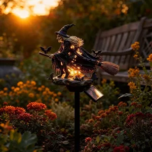 Solar powered Halloween garden stake light featuring an illuminated witch on a broom