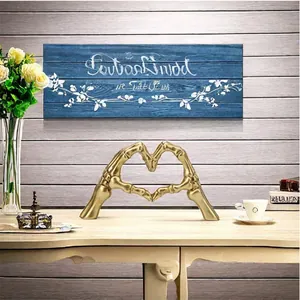 Gold skeleton hands heart resin sculpture as creative gothic home office desk decor