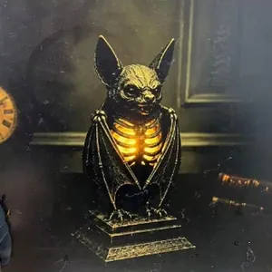 Detail of gothic bat skeleton resin lamp with warm orange glowing ribcage effect