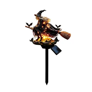 Detailed view of Halloween solar witch garden stake light with warm glowing effect