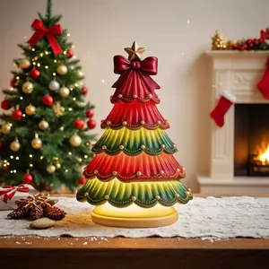 Festive Christmas tree lamp ornament with glowing warm light and decorative red bow