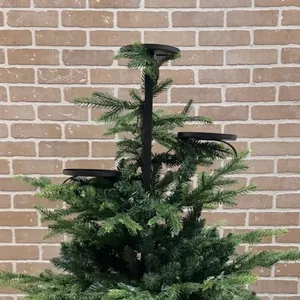 Detail view of black tiered Christmas candle holder stand attached to a festive tree