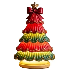 Vintage Christmas tree light ornament with red and green tiers and glowing star topper