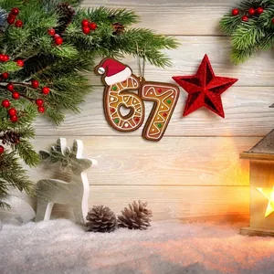 Festive gingerbread number 67 Christmas ornament with Santa hat on wooden background