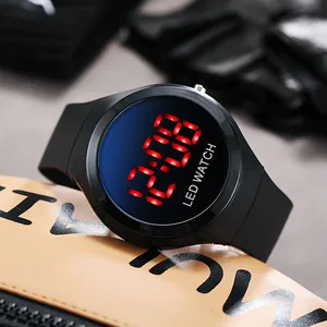 Macro detail view of a black children's LED digital watch with vibrant red display