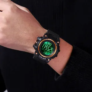 Close-up of a rugged black digital sports watch with a luminous green LED display