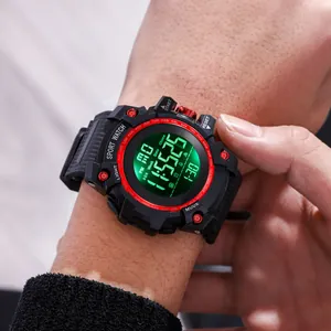 Detail shot of rugged men's digital sports watch with green backlight worn on wrist
