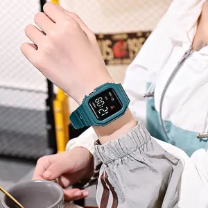 Close-up of a stylish dark green square LED digital watch worn on a wrist in a lifestyle setting