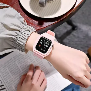 Close-up of a stylish pink square LED digital watch for students on a female wrist.