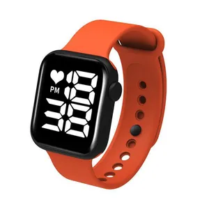Detailed view of a vibrant orange LED digital sports watch featuring a black square face