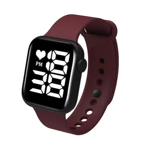 Detailed macro view of a burgundy LED digital watch with a sleek square silicone watch strap