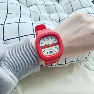 Macro shot of a red square quartz watch with stylized dial details and silicone strap