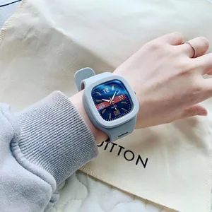 Close-up of a stylish square Klein blue quartz watch with a grey silicone strap
