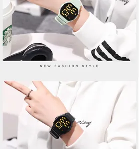 Close-up detail of LED digital sports watch worn on wrist in mint green and black