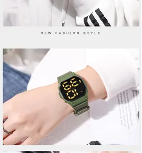 Close-up of green square digital LED sports watch worn on a wrist in a lifestyle setting