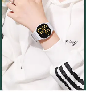 Detailed shot of a minimalist white LED digital sports watch worn over a white hoodie