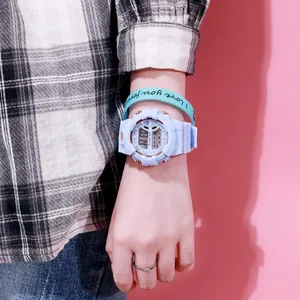 Elegante reloj deportivo digital azul claro en la muñeca con pulsera de silicona.
