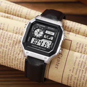 Reloj deportivo digital cuadrado plateado con correa de cuero negro sobre fondo de periódico