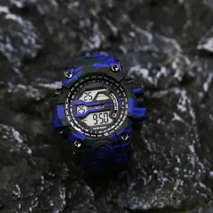 Detailed close-up of a rugged military camouflage digital watch on a dark rock surface