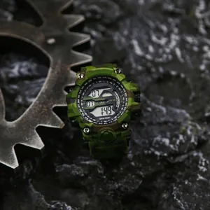 Close-up of green camouflage digital sports watch against rugged background.